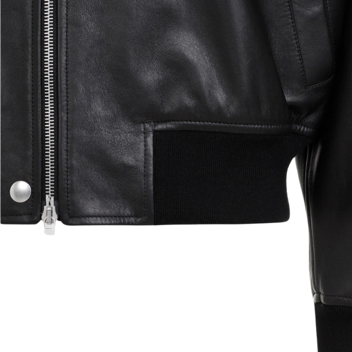 Close up view of black bomber leather jacket's ribbed waistband